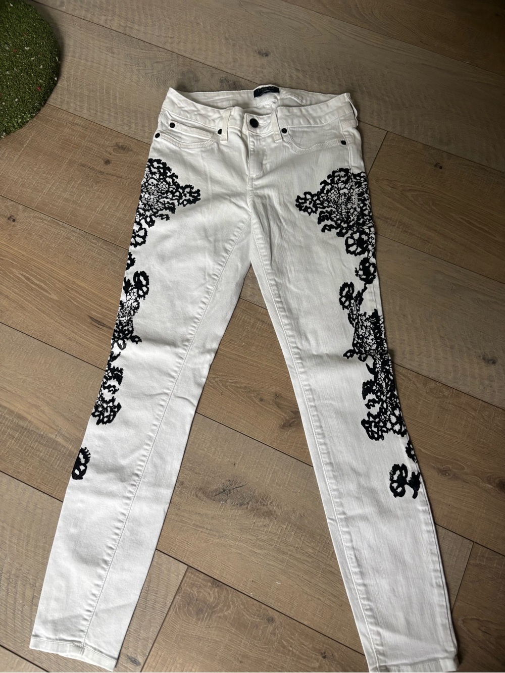 bebe White Skinny Jeans with Black Lace Appliqué